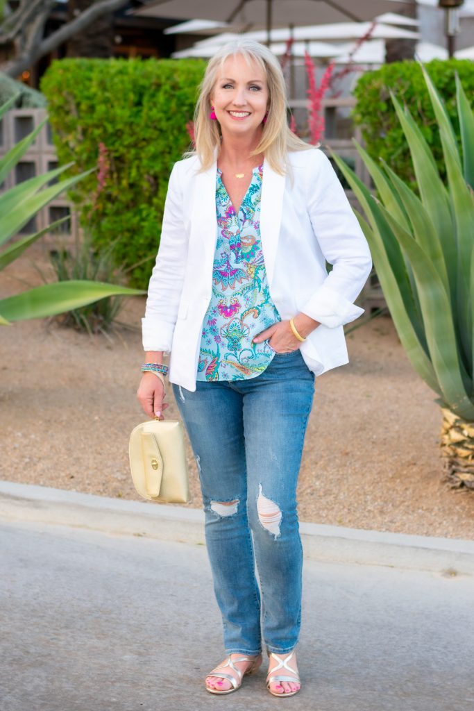white blazer with distressed jeans and floral silk top