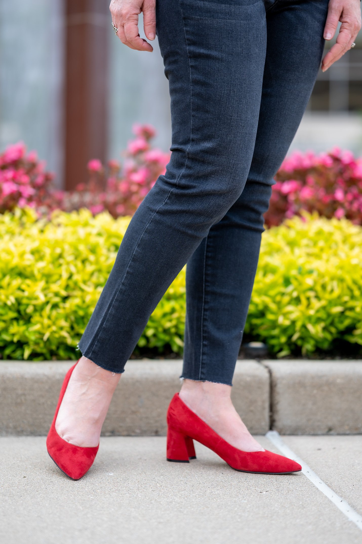 black ankle jeans and red suede pumps