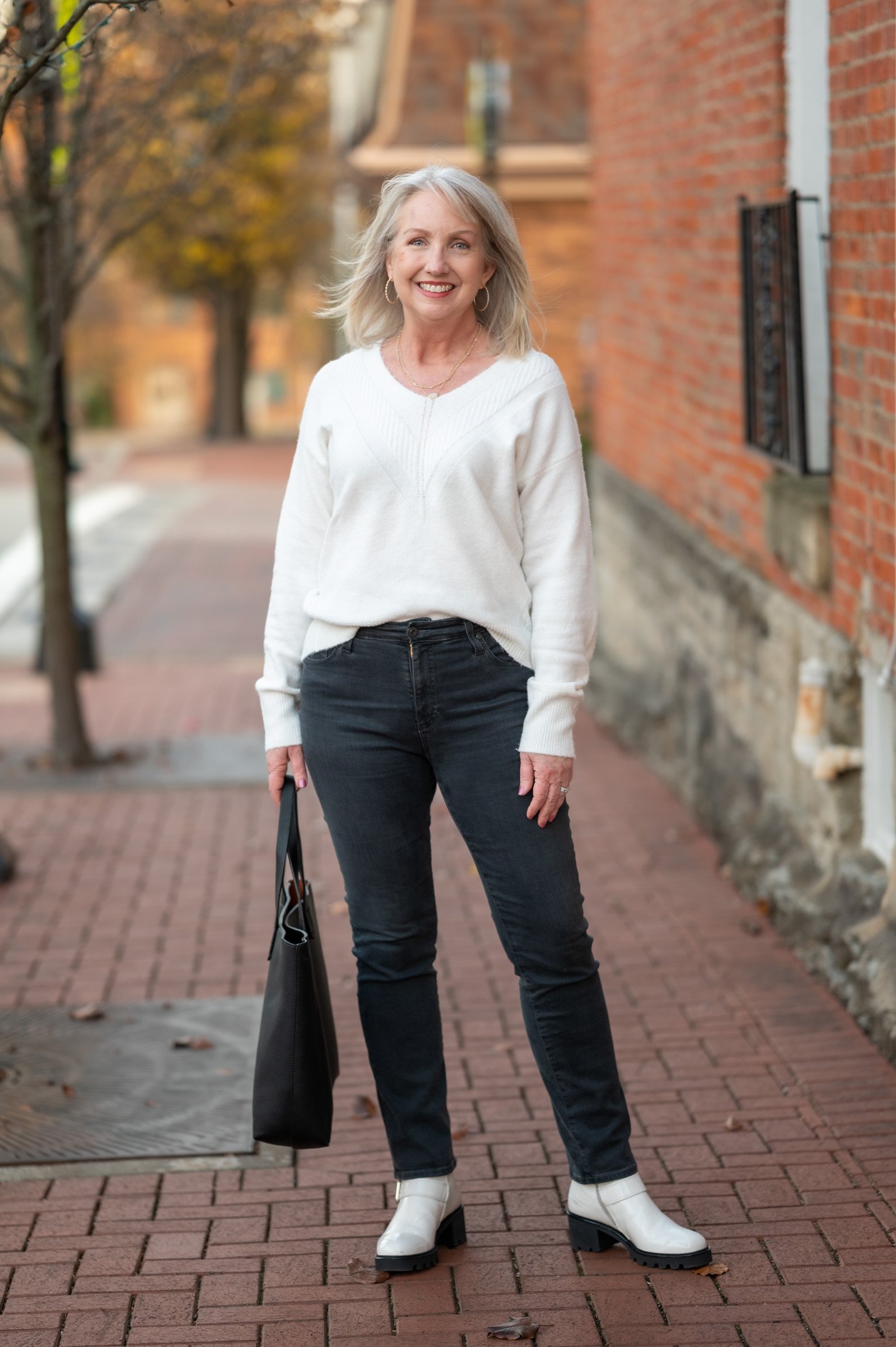 Ivory Sweater and Ivory Boots bookending black jeans